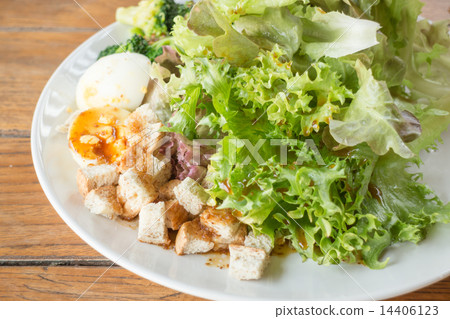 Homemade salad serving on wooden background Homemade salad serving on wooden background 14406123