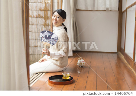 A woman sitting on the verge 14406764