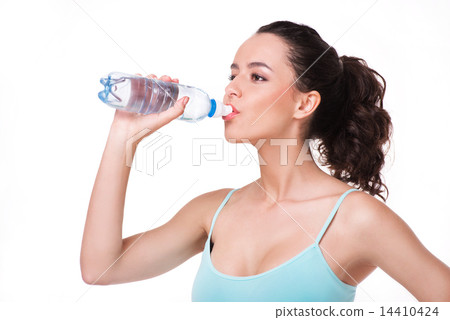 Young sporty woman drinking water Young sporty woman drinking water 14410424