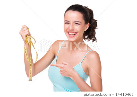 Young woman pointing at measure tape 14410465