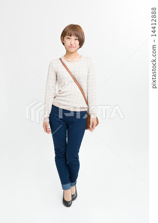 A cute girl in denim and a sweater 14412888