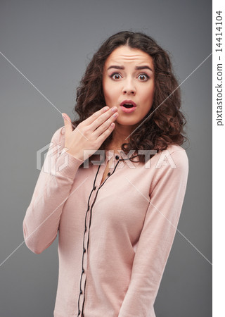 Surprised young woman looking at camera 14414104