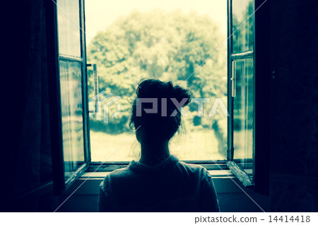 Woman looking through the window Woman looking through the window 14414418