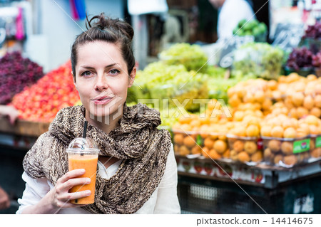 Young happy smiling woman drinking orange juice Young happy smiling woman drinking orange juice 14414675