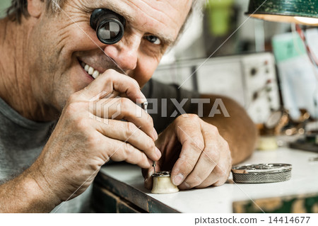 Clockmaker repairing wrist watch. 14414677