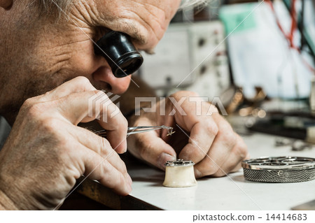 Clockmaker repairing wrist watch. 14414683