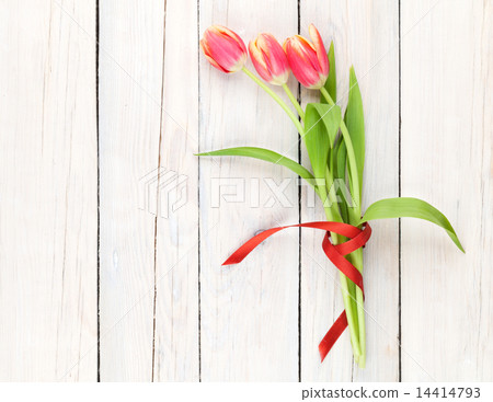 Colorful tulips on wooden table 14414793