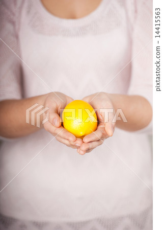 Close up photo of lemon in female hands 14415563