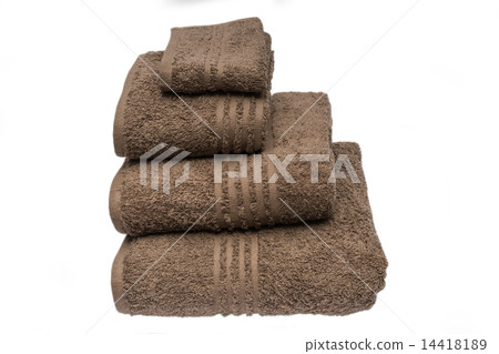 Folded brown bath towels islated in studio on white background 14418189