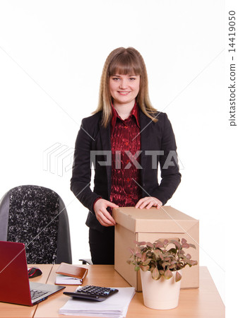 Smiling girl at office desk with a big box 14419050