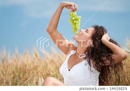 perfect woman eating grapes in wheat field. Picnic. perfect woman eating grapes in wheat field. Picnic. 14419829