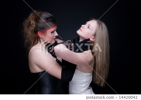 Closeup portrait of two girls: good & evil Closeup portrait of two girls: good & evil 14420042