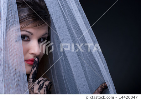Closeup portrait of beautiful girl in white fabric on black Closeup portrait of beautiful girl in white fabric on black 14420047