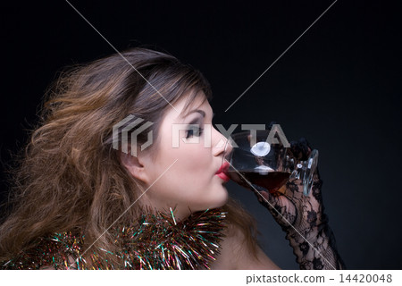 Closeup portrait of girl with red lips, tinsel and wineglass on 14420048