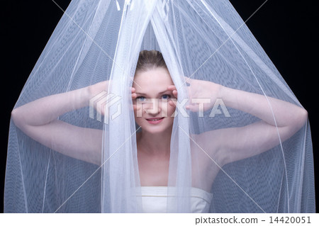 Closeup portrait of beautiful blond girl in white fabric Closeup portrait of beautiful blond girl in white fabric 14420051