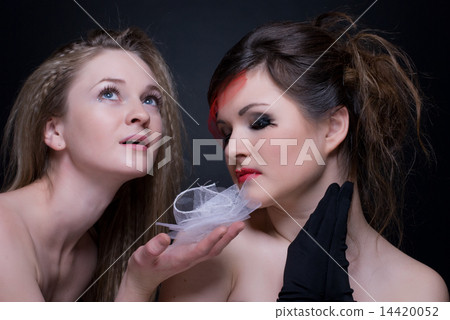 Closeup portrait of two girls: good & evil Closeup portrait of two girls: good & evil 14420052