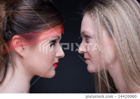 Closeup portrait of two girls: good & evil 14420060