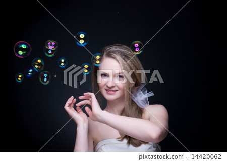 Closeup portrait of blond girl with soap bubbles on black Closeup portrait of blond girl with soap bubbles on black 14420062