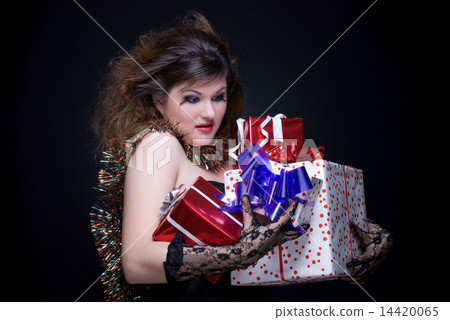 Closeup portrait of girl with red lips, tinsel and present on bl 14420065