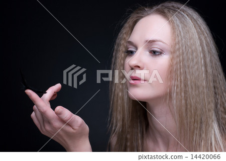 Close up portrait of blond girl with feather on black Close up portrait of blond girl with feather on black 14420066