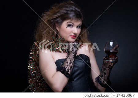Closeup portrait of girl with red lips, tinsel and wineglass on 14420067