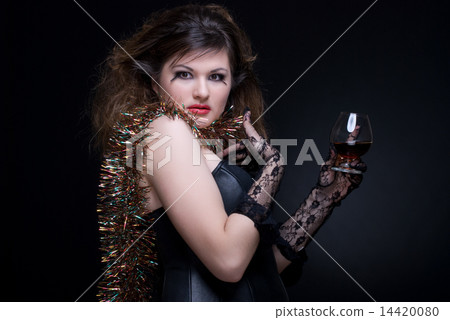 Closeup portrait of girl with red lips, tinsel and wineglass on 14420080