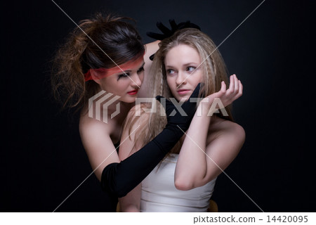 Closeup portrait of two girls: good & evil Closeup portrait of two girls: good & evil 14420095