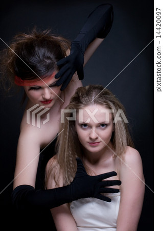 Closeup portrait of two girls: good & evil Closeup portrait of two girls: good & evil 14420097