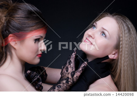 Closeup portrait of two girls: good & evil Closeup portrait of two girls: good & evil 14420098