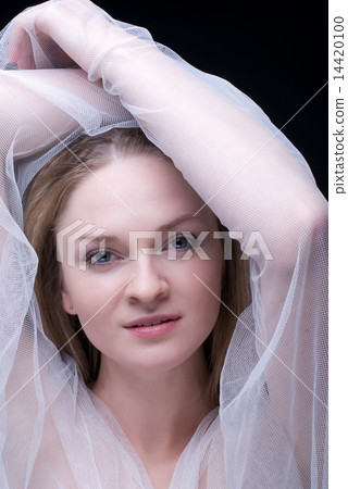 Closeup portrait of beautiful blond girl in white fabric 14420100