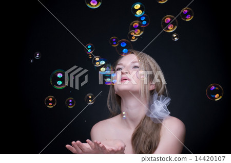 Closeup portrait of blond girl with soap bubbles on black Closeup portrait of blond girl with soap bubbles on black 14420107
