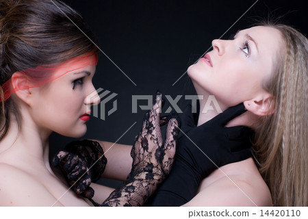 Closeup portrait of two girls: good & evil Closeup portrait of two girls: good & evil 14420110