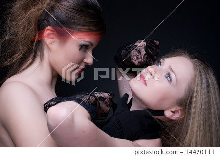 Closeup portrait of two girls: good & evil Closeup portrait of two girls: good & evil 14420111