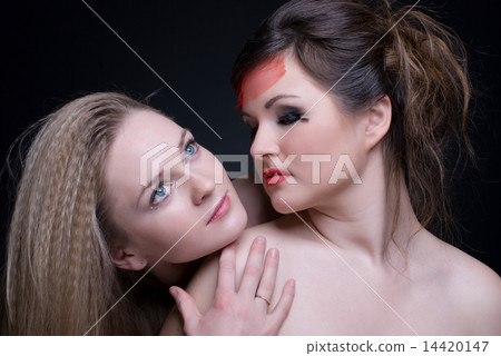 Closeup portrait of two girls: good & evil Closeup portrait of two girls: good & evil 14420147