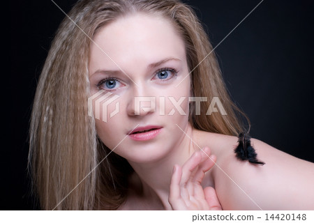 Close up portrait of blond girl with feather on black Close up portrait of blond girl with feather on black 14420148