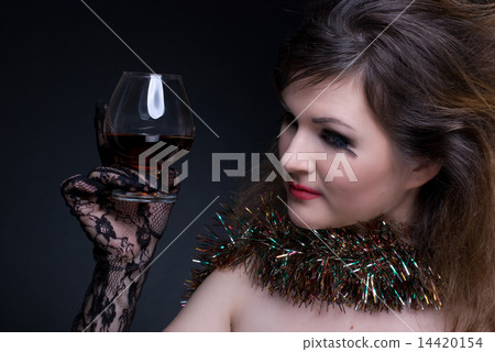 Closeup portrait of girl with red lips, tinsel and wineglass on Closeup portrait of girl with red lips, tinsel and wineglass on 14420154