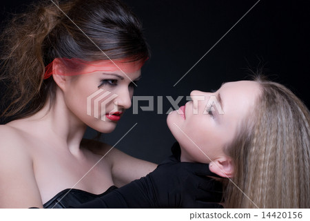 Closeup portrait of two girls: good & evil Closeup portrait of two girls: good & evil 14420156