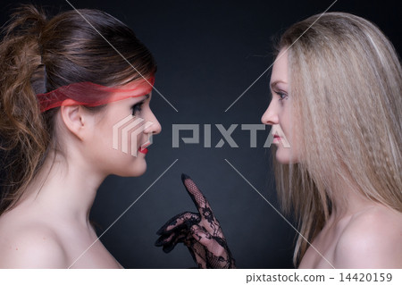 Closeup portrait of two girls: good & evil Closeup portrait of two girls: good & evil 14420159