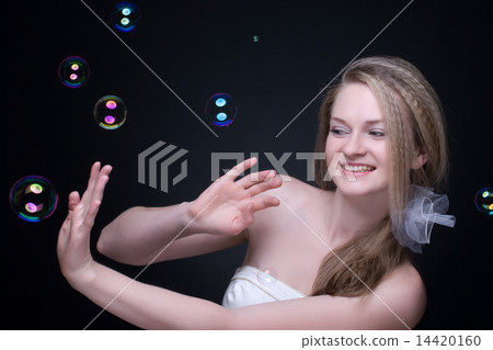 Closeup portrait of blond girl with soap bubbles on black Closeup portrait of blond girl with soap bubbles on black 14420160