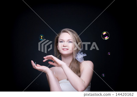 Closeup portrait of blond girl with soap bubbles on black Closeup portrait of blond girl with soap bubbles on black 14420162