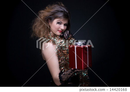 Closeup portrait of girl with red lips, tinsel and present on bl 14420168