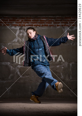 Hip hop dancer in modern style over brick wall 14420619