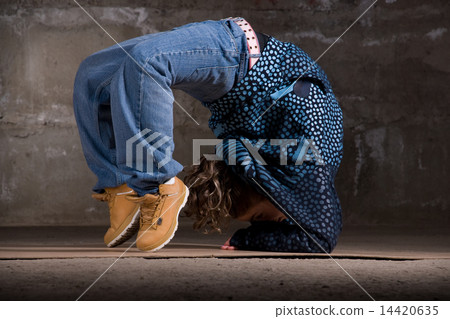 Hip hop dancer in modern style over brick wall Hip hop dancer in modern style over brick wall 14420635