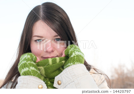 Beautiful girl in green over winter landscape 14420797