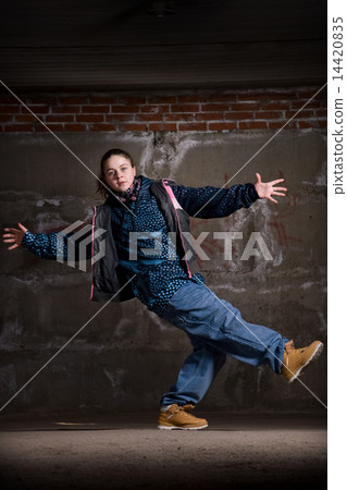 Hip hop dancer in modern style over brick wall Hip hop dancer in modern style over brick wall 14420835