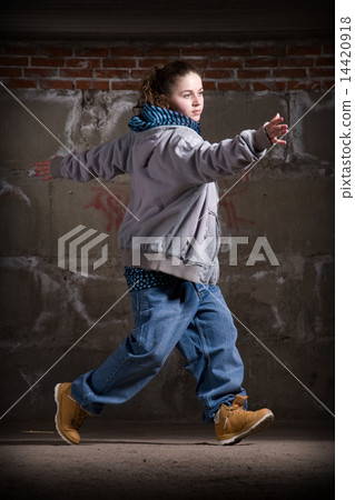 Hip hop dancer in modern style over brick wall 14420918