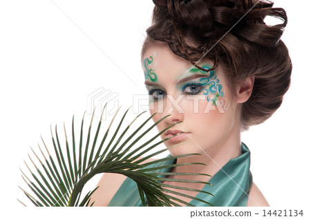 Close-up of sprite girl with faceart and plant Close-up of sprite girl with faceart and plant 14421134