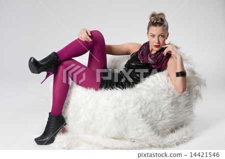 Beautiful young rock girl on fur sofa Beautiful young rock girl on fur sofa 14421546