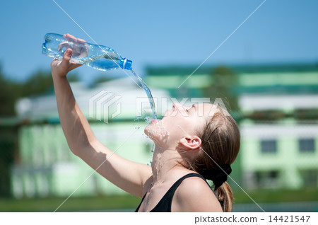 Yyoung woman drinking water after exercise Yyoung woman drinking water after exercise 14421547