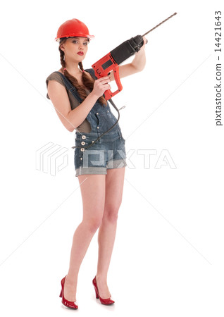 Young playful woman in jeans coverall holding perforator drill Young playful woman in jeans coverall holding perforator drill 14421643